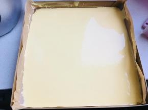 28烤盘放入油纸，油布，硅胶垫均可。将蛋黄糊倒入。抹平。