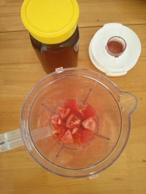 把番茄放入料理杯，加入适量凉白开和两勺蜂蜜。