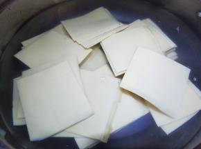 锅里加水放少量食用碱烧开，放豆皮煮两分钟，然后捞起过凉水。