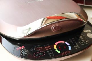 苏泊尔电饼铛先预热一下。烙这个饼需要火大一些，设置手动模式，下盘加热，最大火力。预热完成会听到提示音。