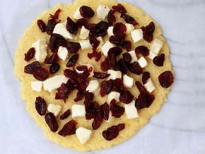 擀成约2毫米厚片，均匀的撒上蔓越莓与奶酪颗粒