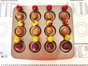 3、按照桃山皮每个15克，月饼馅每个35克，各自称量出12份，每个口味的月饼馅4份对应一种口味的桃山皮(自由搭配），中间一排的彩色桃山皮是用两种口味的桃山皮随意组合后揉在一起的。