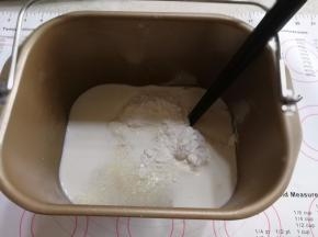 除黄油，盐，酵母，黑芝麻以外的材料放入面包机，用筷子稍微搅拌一下。