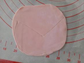 剩下的红色面团继续揉一下，擀成薄片，画出如图中的样子，做为比基尼上衣