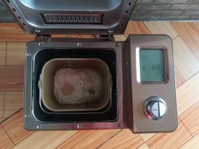 把步骤1的材料放入面包机，选择披萨面团程序（和面15分钟+发酵10分钟）