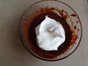 将1/3打发好的蛋白霜加入到蛋黄可可糊里，用刮刀从底部向上翻拌均匀，不要划圈