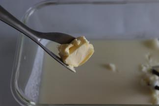 加入黄油，趁热融进去，这步先用勺子或其他工具，铲起，摁压让油融入到冰皮中，稍微等一会，再戴好防粘手套，揉匀，黄油完全的融进去了。这步注意防烫。