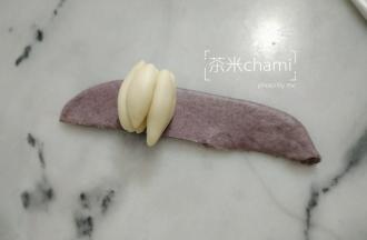 擀平，把黑面片切出合适包裹白色面瓣大小。卷起来，就可以。