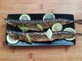 秋刀鱼烤出后取出，挤上适量的柠檬汁，剩下的半个柠檬可以装饰一下，柠檬切扇形放秋刀鱼的身上