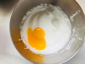 分两次将蛋黄加入到蛋白中，打蛋器搅打均匀。