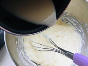 5、	待牛奶的温度降低一些后，倒入芝士糊中，搅拌均匀