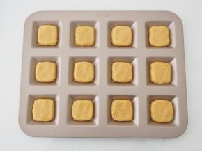 将面团分成12等份，整理成小方形放入模具中