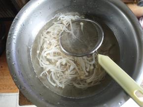 用漏网捞出金针菇，放入冷水降温。