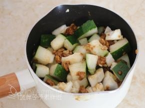 将冬瓜块放入九阳奶锅中，红糖敲碎之后撒上去，并拌匀。
