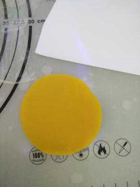 取一个皮料用刮板在硅胶垫上压扁。