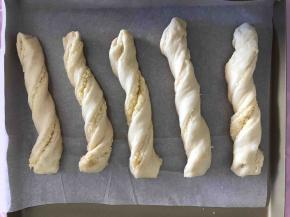 扭转个三四圈放入烤盘中，再放入烤箱进行二次发酵，烤箱下层放一碗热水，保持湿度。