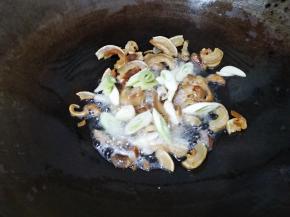放入葱白和蒜片翻炒15秒