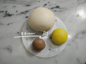 主材料揉均后，140克的白面团待用。
12克的面团揉入南瓜粉，剩下的面团揉入可可粉。