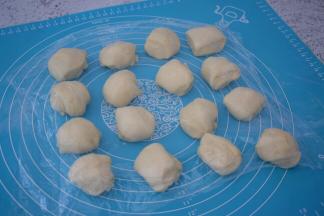 取出面团揉均匀分成16份相同大小的面团，盖上保鲜膜醒发15分钟
