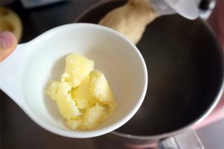 揉至面团光滑出现筋性后加入软化的黄油，先低速后高速继续揉面。