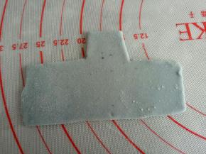 剩余蓝色面团再揉入一点蝶豆花粉做深蓝色面团，擀薄用刮板切出如图猪猪的衣服来