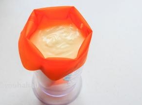 拌匀的面糊装入裱花袋中，小编用的是硅胶裱花袋，可以重复使用，裱花岛放入大的量杯中，方便倒入面糊，裱花袋的前开口用夹子先夹住，用的时候再打开。