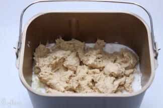 把主面团食材，除黄油外，与中种面团一同放入面包桶内。