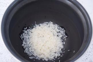 把淘洗干净的大米倒入电饭煲内胆
