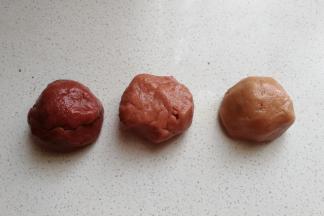 然后每一份都各自加入不同量的红曲粉揉均匀，使其形成三个渐变颜色的红面团。