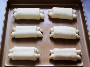 把做好的面包翻过来，在烤盘上摆好后进行二发，现在的天气很热，不需要烤箱加热水一会就可以发好了