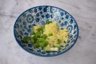 在烤花蛤时来制作酱汁，把蒜姜葱放入碗中