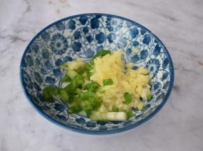 在烤花蛤时来制作酱汁，把蒜姜葱放入碗中