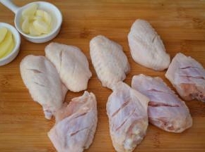 鸡翅洗净用刀在鸡翅正反面各切两刀，方便入味，姜切片，蒜切片备用