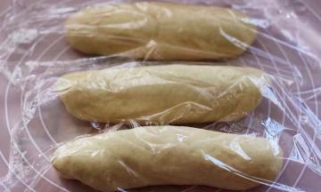 上下用擀面杖擀成椭圆型，从上往下卷，再静置15分钟后