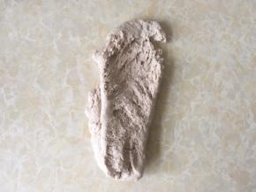 倒在揉面垫上，用手掌一直向前推揉，将面团推揉至起筋状态
