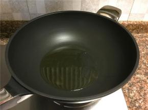 热锅倒油烧至八成热。