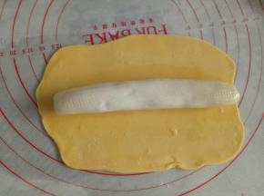 将白色内芯涂抹一层食用油，放到黄色面片上，包起来，捏紧收口，收口向下