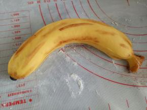 用细毛笔蘸一点水再蘸一点可可粉，刷到香蕉上面，这样更显逼真