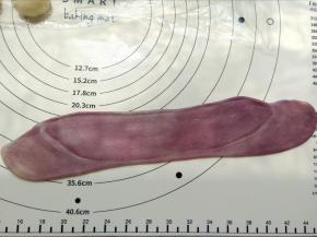 松弛好后再次擀成牛舌形，卷起来盖上保鲜膜松弛15分钟。