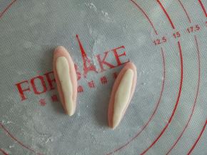 将面团稍微压扁，用1克的白面团如图盖到兔兔的耳朵上，这样更加好看一点也显逼真
