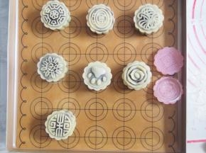 将所有的月饼胚都这样包好，模具沾一层面粉，将月饼胚放入模具后压出纹路。