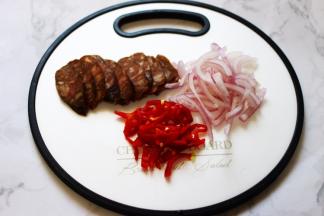 风干肠用刀切成薄片，洋葱切丝，红椒切丝备用