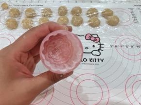 12、月饼模具装好，里面均匀的撒少许玉米淀粉后倒出多余的粉。