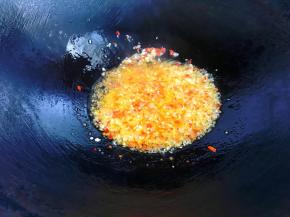 锅里倒入适量油，油温四成热时倒入蒜蓉，小火煸至微黄后加入小米椒继续煸香。