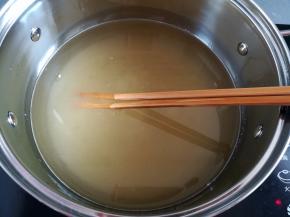 用筷子把白砂糖搅拌到融化