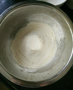 玉米油和牛奶混合，搅打至乳化。然后筛入低筋面粉，翻拌均匀。