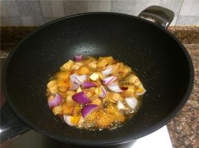 放入洋葱和蒜片翻炒30秒。