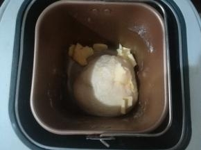 揉至光滑有筋度，可以拉出厚膜。然后加入软化的黄油。