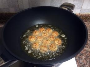 将肉丸再翻面炸制。