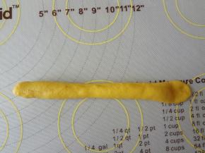 自上而下的卷起来，一端压扁把另一端的面团裹起来